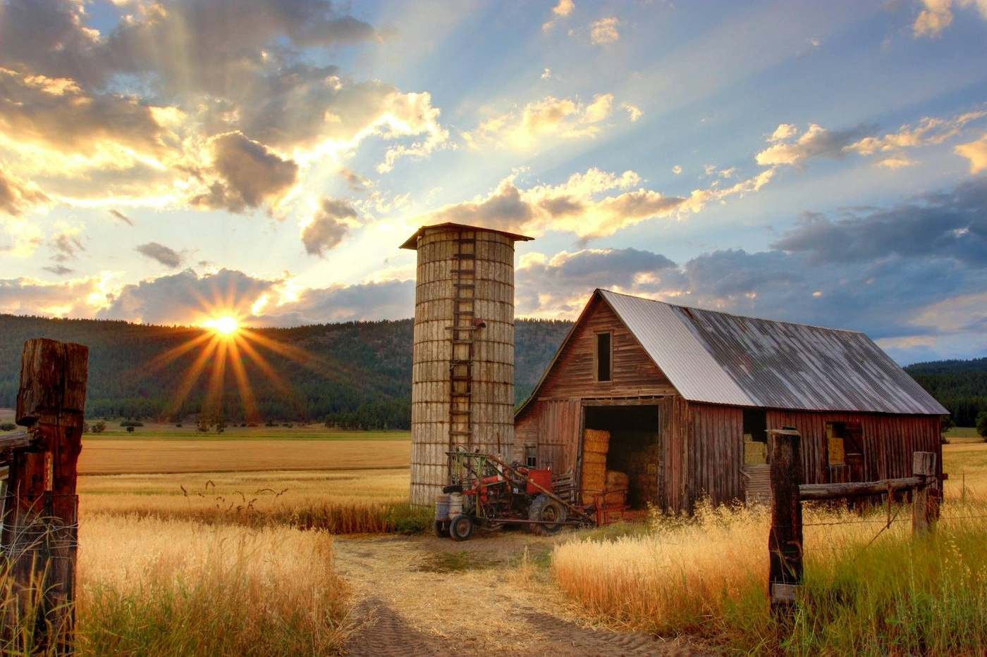 Barn and open land at sunset
